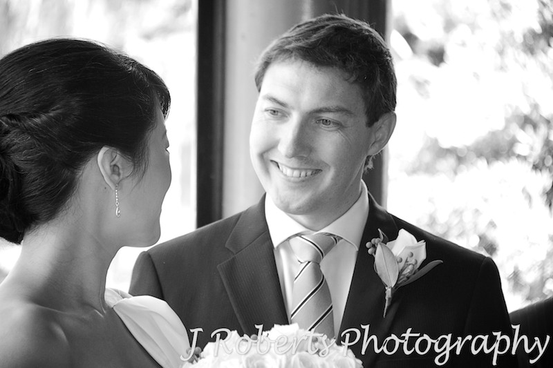 Groom smiling at bride during wedding ceremony - wedding photography sydney